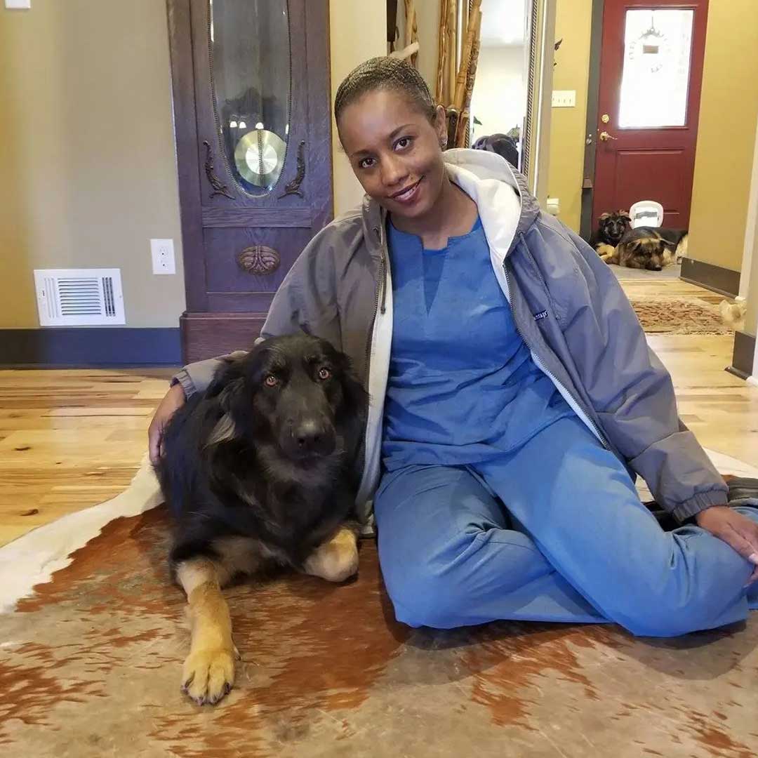 Dr. Erika Venable sitting right next to a dog